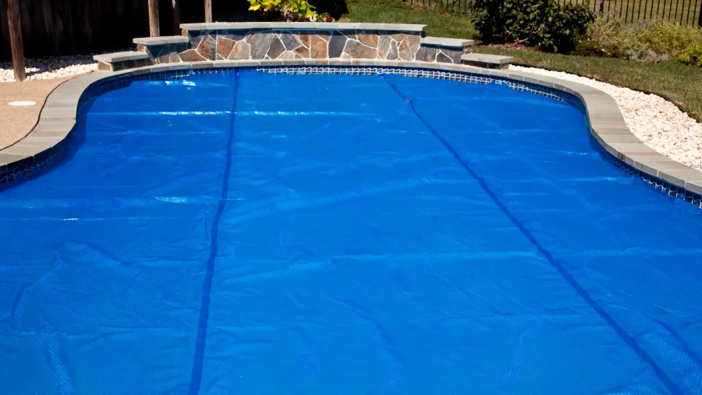 How long does it take to heat a pool - A pool with a cover over it